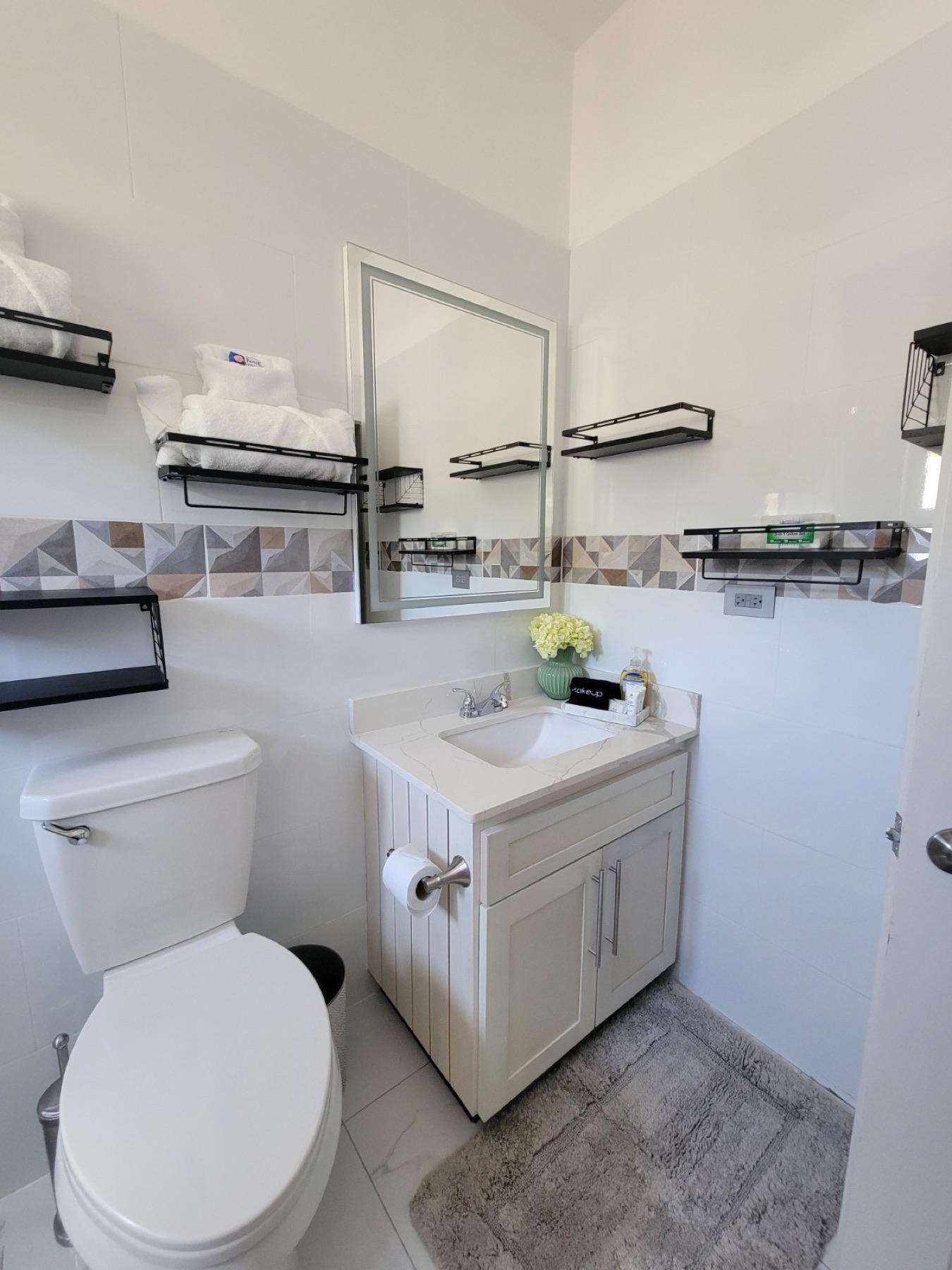 An en-suite bathroom with a walk-in shower and a wide mirror