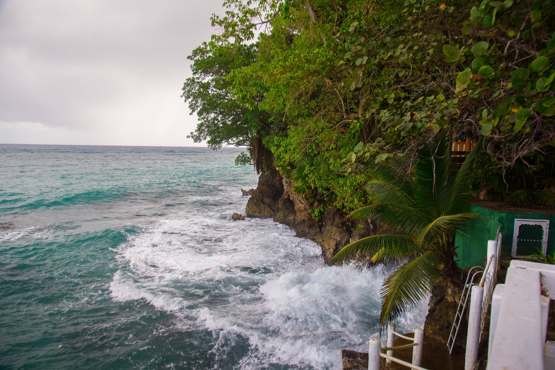 Steps down to the sea, waves breaking against the rocks below